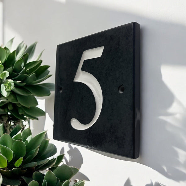 Introducing our stunning 10cm x 10cm Polished Natural Slate House Sign, designed to make a lasting impression! Crafted with durability in mind, it features beautifully carved lettering that enhances its elegance and visibility. Transform your home's entrance with this exquisite sign! www.HouseSign.co.uk