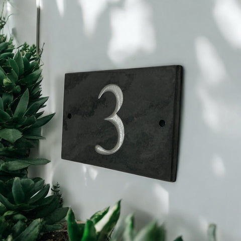 Introducing our stunning 12.5cm x 7.5cm Polished Natural Slate House Sign, designed to make a lasting impression! Crafted with durability in mind, it features beautifully carved lettering that enhances its elegance and visibility. Transform your home's entrance with this exquisite sign! www.HouseSign.co.uk