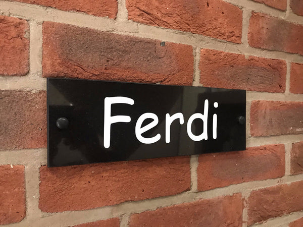 A black square House Sign with clear deep-cut numbers featuring a green plant placed elegantly on its surface www.HouseSign.co.uk