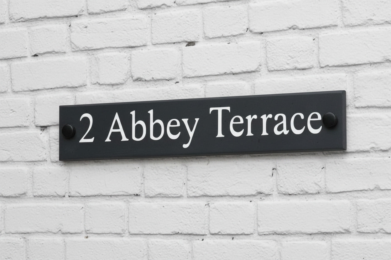 Introducing our stunning 30cm x 5cm Polished Natural Slate House Sign, designed to make a lasting impression! Crafted with durability in mind, it features beautifully carved lettering that enhances its elegance and visibility. Transform your home's entrance with this exquisite sign! www.HouseSign.co.uk