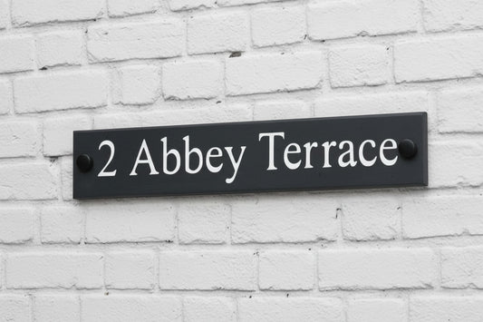 Introducing our stunning 30cm x 5cm Polished Natural Slate House Sign, designed to make a lasting impression! Crafted with durability in mind, it features beautifully carved lettering that enhances its elegance and visibility. Transform your home's entrance with this exquisite sign! www.HouseSign.co.uk