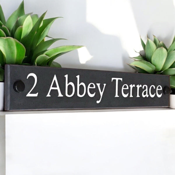 Introducing our stunning 30cm x 5cm Polished Natural Slate House Sign, designed to make a lasting impression! Crafted with durability in mind, it features beautifully carved lettering that enhances its elegance and visibility. Transform your home's entrance with this exquisite sign! www.HouseSign.co.uk