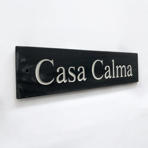 Introducing our stunning 30cm x 7.5cm Polished Natural Slate House Sign, designed to make a lasting impression! Crafted with durability in mind, it features beautifully carved lettering that enhances its elegance and visibility. Transform your home's entrance with this exquisite sign! www.HouseSign.co.uk