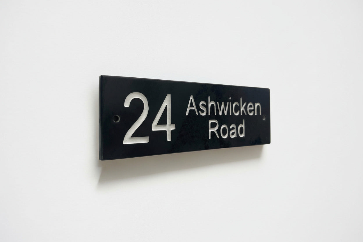 Introducing our stunning 30cm x 7.5cm Polished Natural Slate House Sign, designed to make a lasting impression! Crafted with durability in mind, it features beautifully carved lettering that enhances its elegance and visibility. Transform your home's entrance with this exquisite sign! www.HouseSign.co.uk