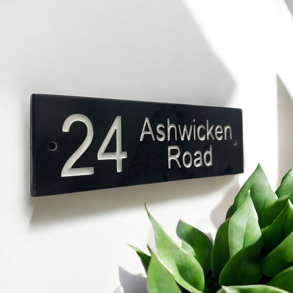 Introducing our stunning 30cm x 7.5cm Polished Natural Slate House Sign, designed to make a lasting impression! Crafted with durability in mind, it features beautifully carved lettering that enhances its elegance and visibility. Transform your home's entrance with this exquisite sign! www.HouseSign.co.uk