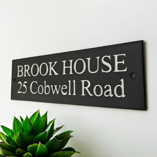 Introducing our stunning 30cm x 10cm Polished Natural Slate House Sign, designed to make a lasting impression! Crafted with durability in mind, it features beautifully carved lettering that enhances its elegance and visibility. Transform your home's entrance with this exquisite sign! www.HouseSign.co.uk
