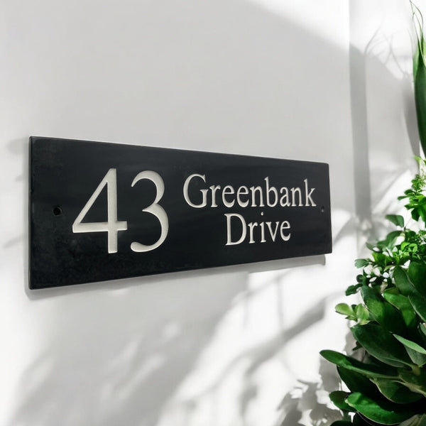 Introducing our stunning 30cm x 10cm Polished Natural Slate House Sign, designed to make a lasting impression! Crafted with durability in mind, it features beautifully carved lettering that enhances its elegance and visibility. Transform your home's entrance with this exquisite sign! www.HouseSign.co.uk