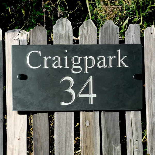 Introducing our stunning 30cm x 15cm Polished Natural Slate House Sign, designed to make a lasting impression! Crafted with durability in mind, it features beautifully carved lettering that enhances its elegance and visibility. Transform your home's entrance with this exquisite sign! www.HouseSign.co.uk