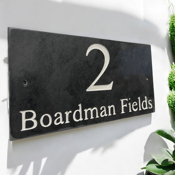 Introducing our stunning 30cm x 15cm Polished Natural Slate House Sign, designed to make a lasting impression! Crafted with durability in mind, it features beautifully carved lettering that enhances its elegance and visibility. Transform your home's entrance with this exquisite sign! www.HouseSign.co.uk