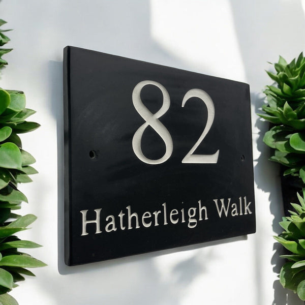 Introducing our stunning 30cm x 20cm Polished Natural Slate House Sign, designed to make a lasting impression! Crafted with durability in mind, it features beautifully carved lettering that enhances its elegance and visibility. Transform your home's entrance with this exquisite sign! www.HouseSign.co.uk