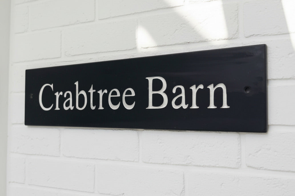 Introducing our stunning 40cm x 7.5cm Polished Natural Slate House Sign, designed to make a lasting impression! Crafted with durability in mind, it features beautifully carved lettering that enhances its elegance and visibility. Transform your home's entrance with this exquisite sign! www.HouseSign.co.uk