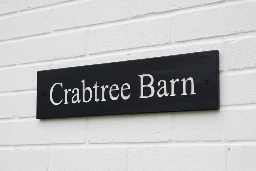 Introducing our stunning 40cm x 10cm Polished Natural Slate House Sign, designed to make a lasting impression! Crafted with durability in mind, it features beautifully carved lettering that enhances its elegance and visibility. Transform your home's entrance with this exquisite sign! www.HouseSign.co.uk