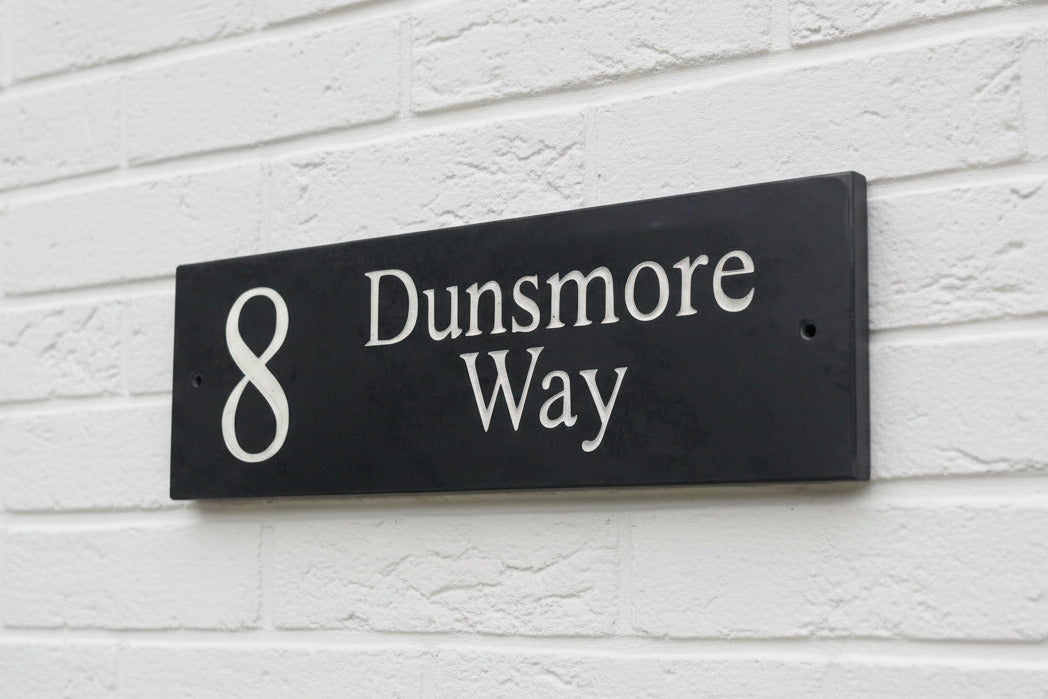 Introducing our stunning 40cm x 10cm Polished Natural Slate House Sign, designed to make a lasting impression! Crafted with durability in mind, it features beautifully carved lettering that enhances its elegance and visibility. Transform your home's entrance with this exquisite sign! www.HouseSign.co.uk
