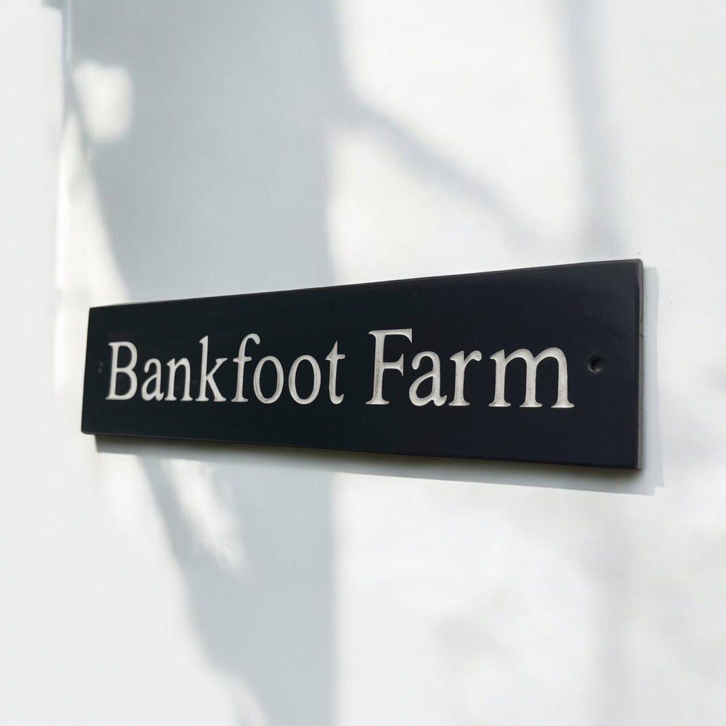 Introducing our stunning 40cm x 10cm Polished Natural Slate House Sign, designed to make a lasting impression! Crafted with durability in mind, it features beautifully carved lettering that enhances its elegance and visibility. Transform your home's entrance with this exquisite sign! www.HouseSign.co.uk