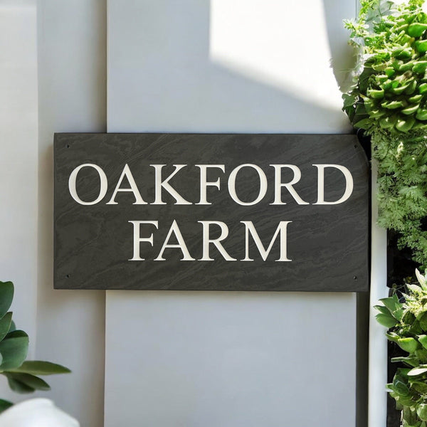 Introducing our stunning 41cm x 22.5cm Polished Natural Slate House Sign, designed to make a lasting impression! Crafted with durability in mind, it features beautifully carved lettering that enhances its elegance and visibility. Transform your home's entrance with this exquisite sign! www.HouseSign.co.uk
