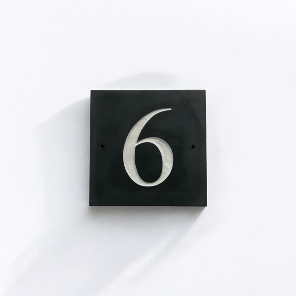 Introducing our stunning 10cm x 10cm Polished Natural Slate House Sign, designed to make a lasting impression! Crafted with durability in mind, it features beautifully carved lettering that enhances its elegance and visibility. Transform your home's entrance with this exquisite sign! www.HouseSign.co.uk