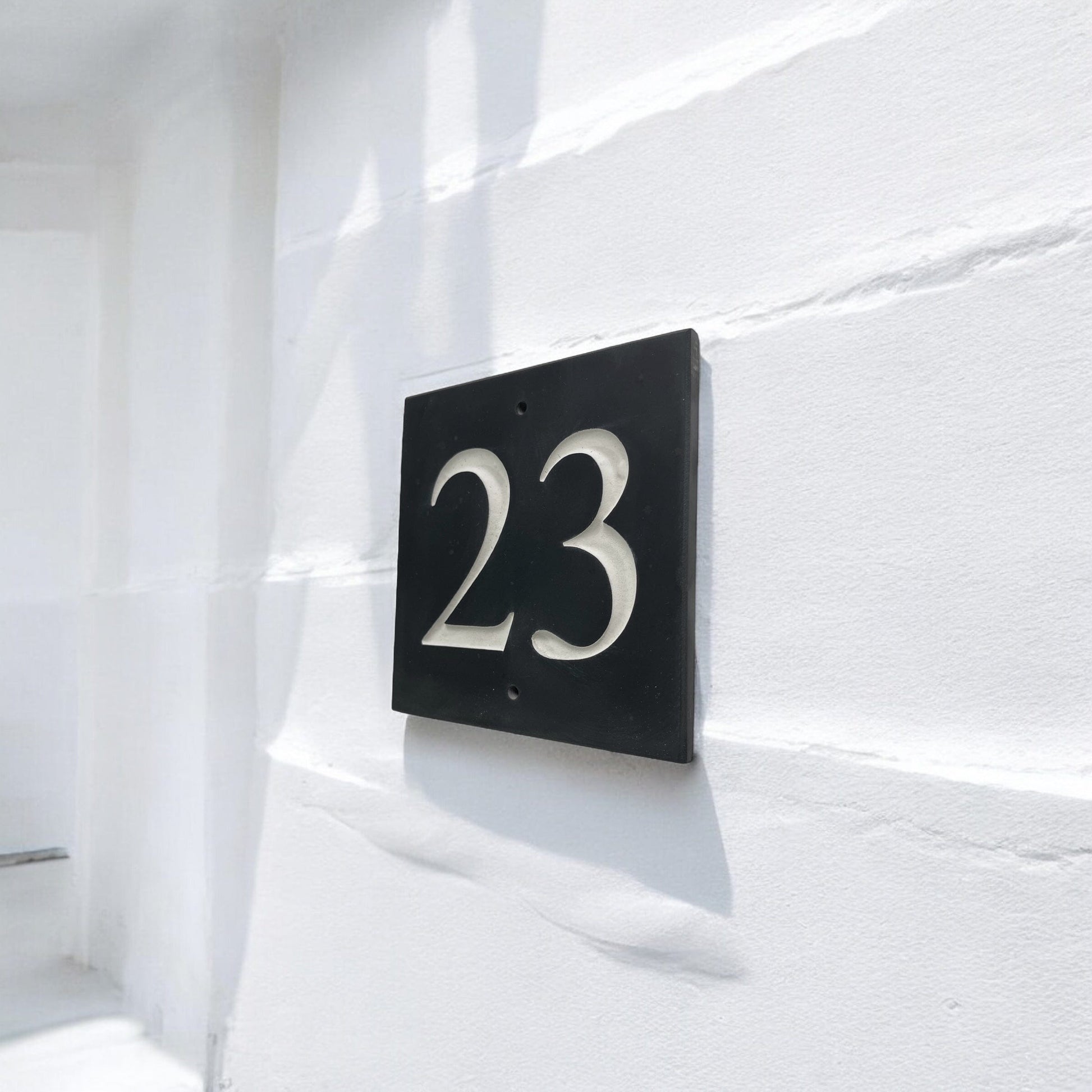 Introducing our stunning 10cm x 10cm Polished Natural Slate House Sign, designed to make a lasting impression! Crafted with durability in mind, it features beautifully carved lettering that enhances its elegance and visibility. Transform your home's entrance with this exquisite sign! www.HouseSign.co.uk