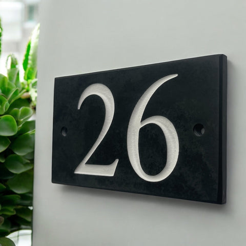 Introducing our stunning 12.5cm x 7.5cm Polished Natural Slate House Sign, designed to make a lasting impression! Crafted with durability in mind, it features beautifully carved lettering that enhances its elegance and visibility. Transform your home's entrance with this exquisite sign! www.HouseSign.co.uk