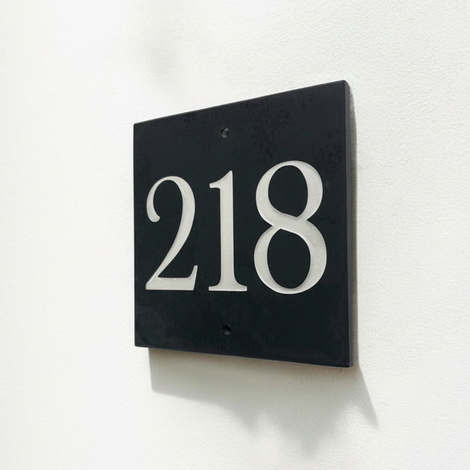 Introducing our stunning 15cm x 15cm Polished Natural Slate House Sign, designed to make a lasting impression! Crafted with durability in mind, it features beautifully carved lettering that enhances its elegance and visibility. Transform your home's entrance with this exquisite sign! www.HouseSign.co.uk