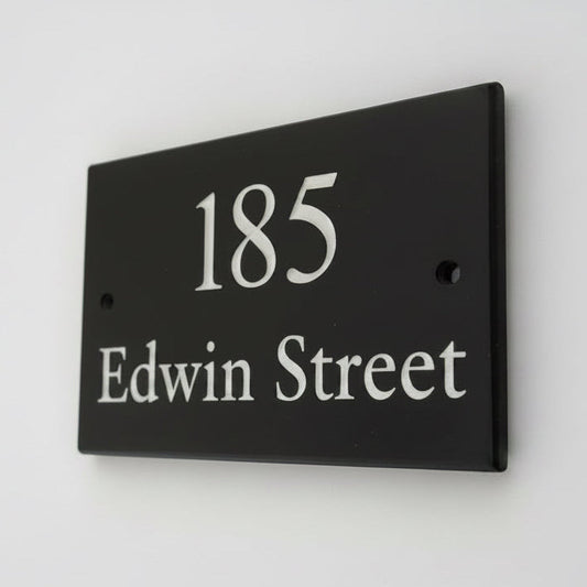 Introducing our stunning 20cm x 10cm Polished Natural Slate House Sign, designed to make a lasting impression! Crafted with durability in mind, it features beautifully carved lettering that enhances its elegance and visibility. Transform your home's entrance with this exquisite sign! www.HouseSign.co.uk