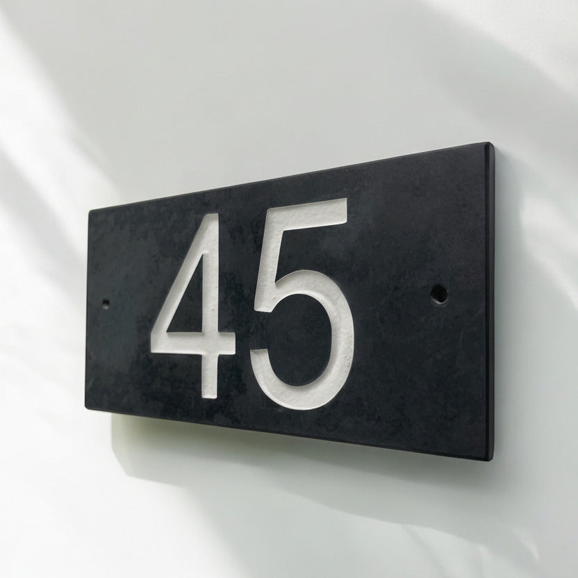 Introducing our stunning 20cm x 10cm Polished Natural Slate House Sign, designed to make a lasting impression! Crafted with durability in mind, it features beautifully carved lettering that enhances its elegance and visibility. Transform your home's entrance with this exquisite sign! www.HouseSign.co.uk