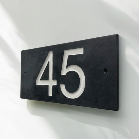 Introducing our stunning 20cm x 10cm Polished Natural Slate House Sign, designed to make a lasting impression! Crafted with durability in mind, it features beautifully carved lettering that enhances its elegance and visibility. Transform your home's entrance with this exquisite sign! www.HouseSign.co.uk