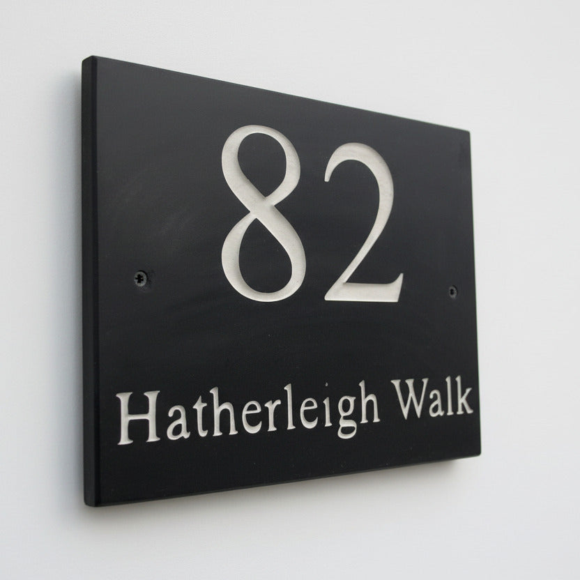 Introducing our stunning 20cm x 15cm Polished Natural Slate House Sign, designed to make a lasting impression! Crafted with durability in mind, it features beautifully carved lettering that enhances its elegance and visibility. Transform your home's entrance with this exquisite sign! www.HouseSign.co.uk