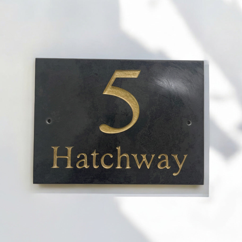 Introducing our stunning 20cm x 15cm Polished Natural Slate House Sign, designed to make a lasting impression! Crafted with durability in mind, it features beautifully carved lettering that enhances its elegance and visibility. Transform your home's entrance with this exquisite sign! www.HouseSign.co.uk