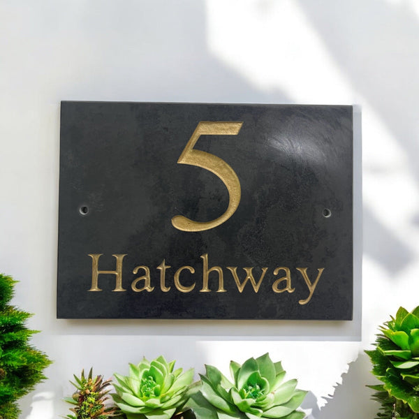 Introducing our stunning 20cm x 15cm Polished Natural Slate House Sign, designed to make a lasting impression! Crafted with durability in mind, it features beautifully carved lettering that enhances its elegance and visibility. Transform your home's entrance with this exquisite sign! www.HouseSign.co.uk