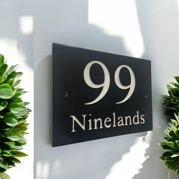 Introducing our stunning 20cm x 15cm Polished Natural Slate House Sign, designed to make a lasting impression! Crafted with durability in mind, it features beautifully carved lettering that enhances its elegance and visibility. Transform your home's entrance with this exquisite sign! www.HouseSign.co.uk