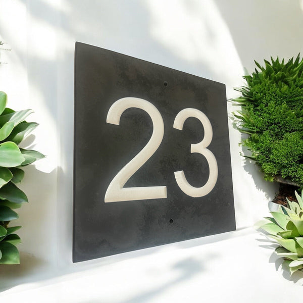 Introducing our stunning 22.5cm x 22.5cm Polished Natural Slate House Sign, designed to make a lasting impression! Crafted with durability in mind, it features beautifully carved lettering that enhances its elegance and visibility. Transform your home's entrance with this exquisite sign! www.HouseSign.co.uk