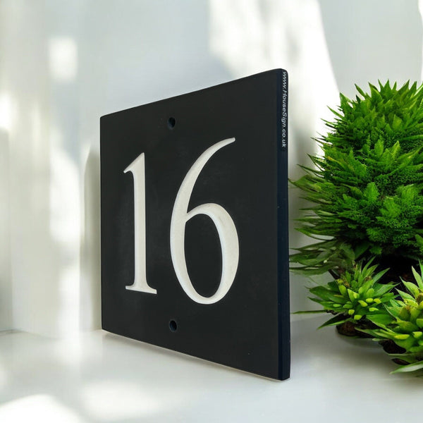 Introducing our stunning 22.5cm x 22.5cm Polished Natural Slate House Sign, designed to make a lasting impression! Crafted with durability in mind, it features beautifully carved lettering that enhances its elegance and visibility. Transform your home's entrance with this exquisite sign! www.HouseSign.co.uk