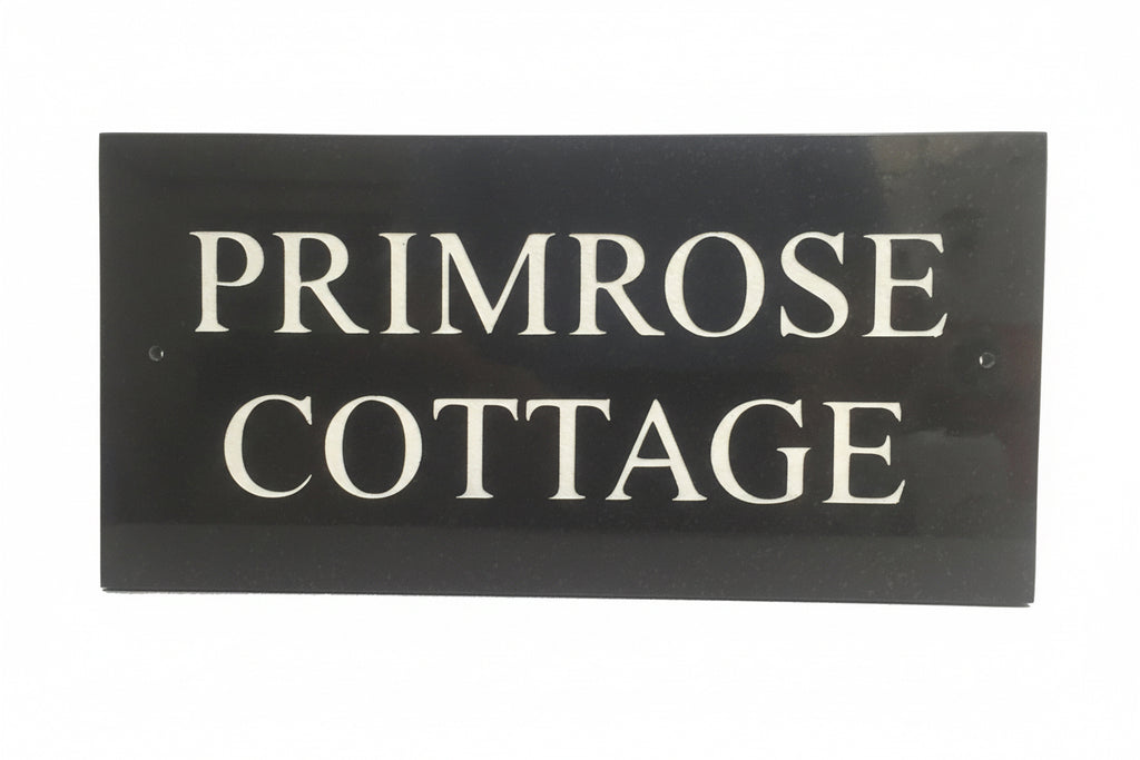 A black square House Sign with clear deep-cut numbers featuring a green plant placed elegantly on its surface www.HouseSign.co.uk 