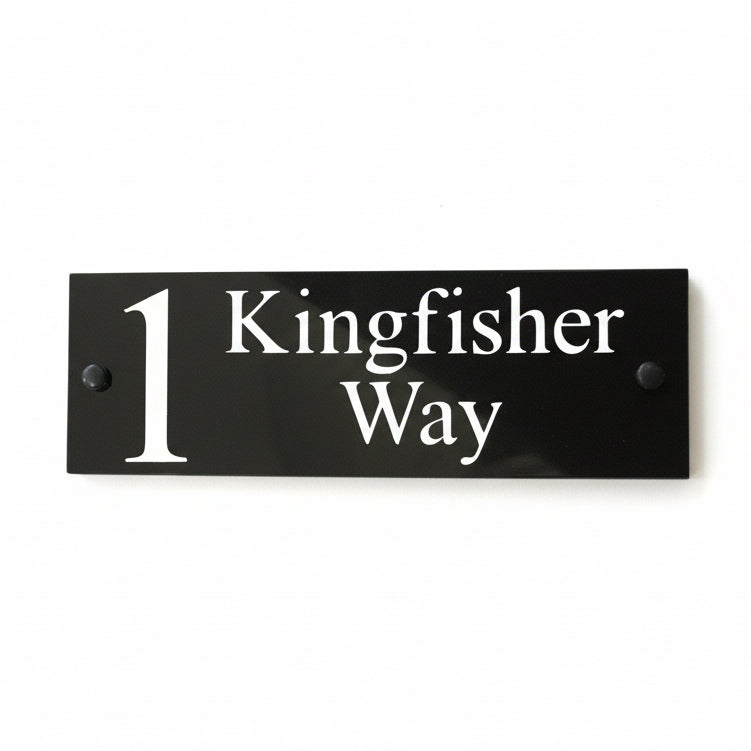 A black square House Sign with clear deep-cut numbers featuring a green plant placed elegantly on its surface www.HouseSign.co.uk 