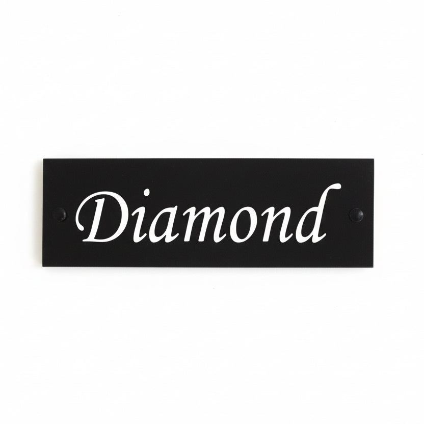 A black square House Sign with clear deep-cut numbers featuring a green plant placed elegantly on its surface www.HouseSign.co.uk 