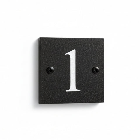 A black square House Sign with clear to see deep cut numbers featuring a green plant placed elegantly on its surface www.HouseSign.co.uk 