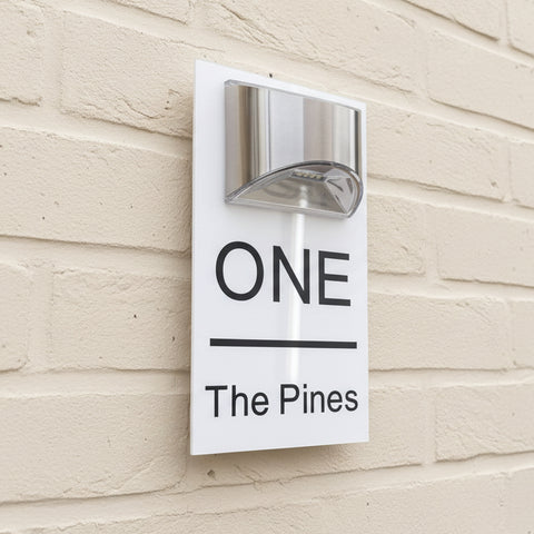 LED Solar House Sign on a cream-painted wall. www.HouseSign.co.uk