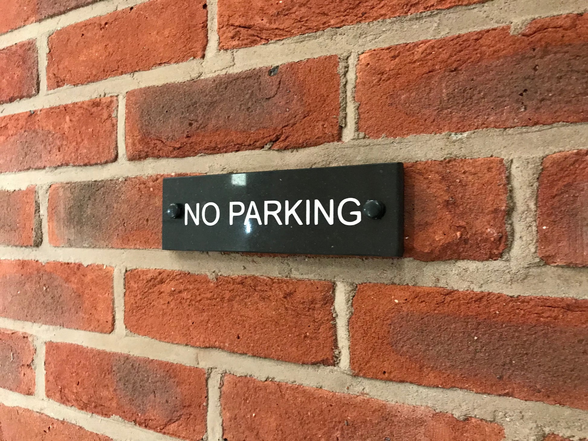 A No Parking Sign made in Natural Slate with polished edges and hard-wearing carved lettering www.HouseSign.co.uk